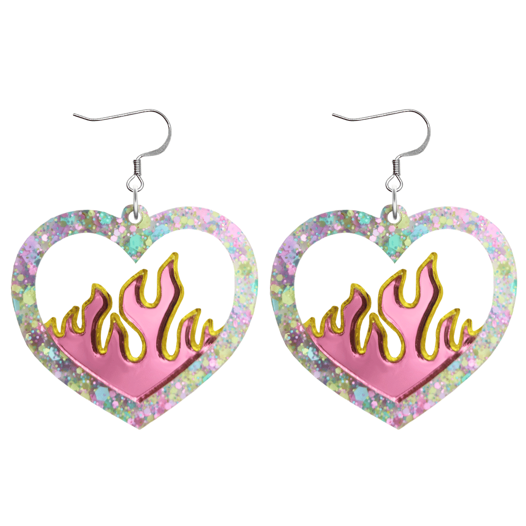 Heart-shaped earrings with flame design and multicolored glittery border on a white background with hooks