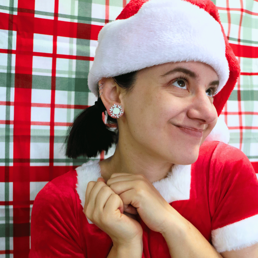 model wearing santa outfit and santa hat with haus of dizzy ice ice baby snowflake studs in silver mirror
