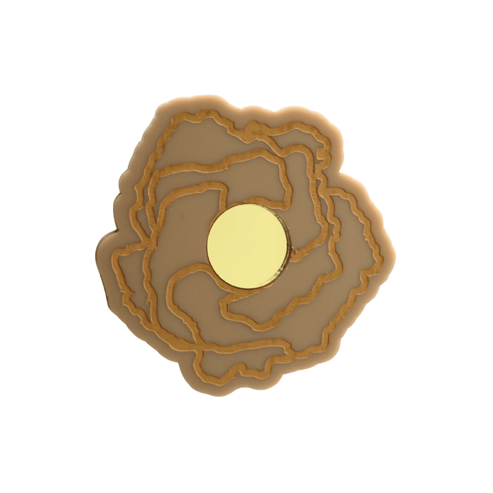 haus of dizzy x kylie monteleone collab badge with aboriginal art that depicts the desert rose. using cappuccino matte acrylic and tan hand painted details on flower with a gold mirror acrylic centre. he desert rose thrives in harsh conditions as do we. badge comes with secure locking pin to ensure all day wear. badge is 5.7cm.
