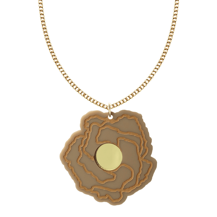 haus of dizzy x kylie monteleone collab necklace with aboriginal art that depicts the desert rose. using cappuccino matte acrylic and light brown hand painted details on flower with a gold mirror acrylic centre. the desert rose thrives in harsh conditions as do we. charm size is 5.7cm on a gold chain.