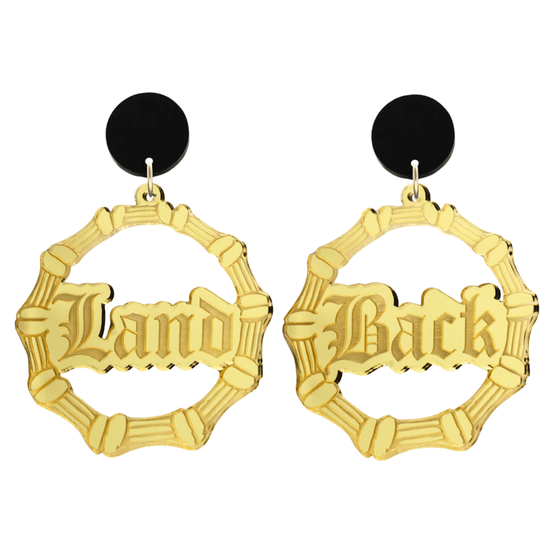 haus of dizzy acrylic gold mirror bamboo hoops with old english text that reads Land Back, one word on each earring, with black circle stud tops size large