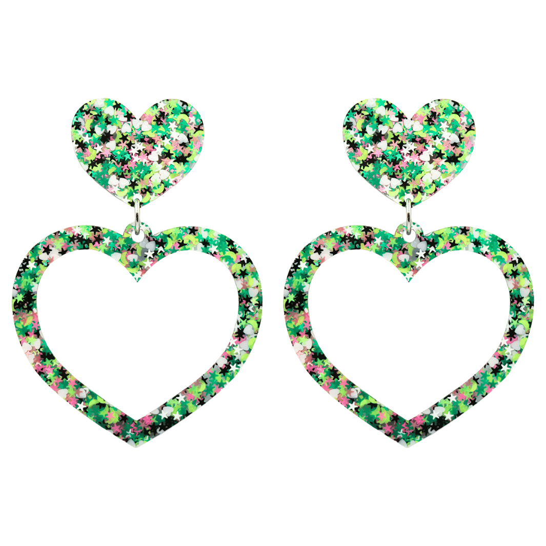 An image of haus of dizzy limited edition barbie heart earrings in colour jungle star. they are two layer heart-shaped earrings with multicolored glitter (greens, white, black, and pink) size large 