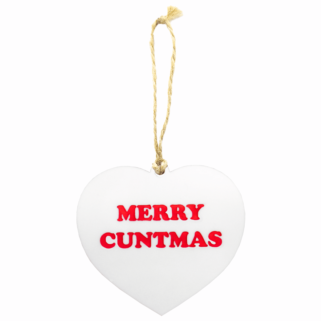 hau of dizzy Heart-shaped white ornament with 'MERRY CUNTMAS' in red text on a white background