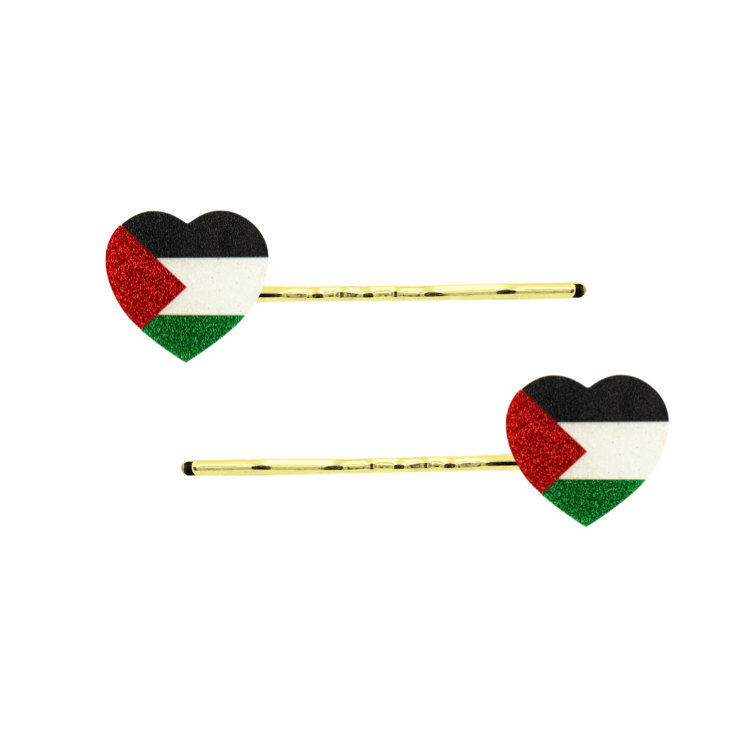 Two gold bobby pins with heart-shaped flags featuring the Palestinian flag design, shown on a plain white background.