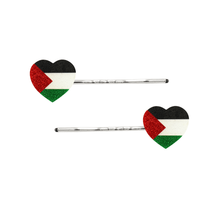 Two silver bobby pins with heart-shaped flags featuring the Palestinian flag design in black, white, red, and green glitter, shown on a plain white background.