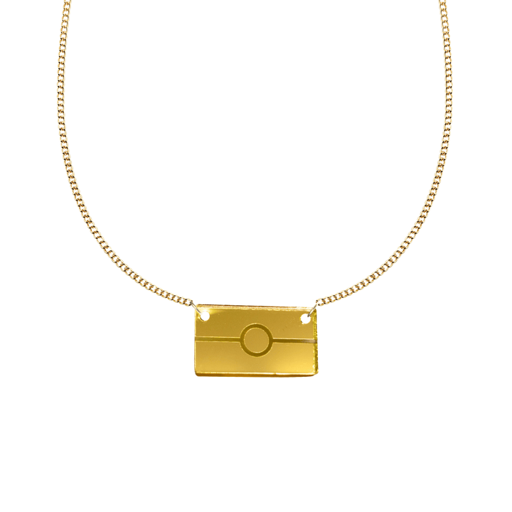 Gold mirror acrylic rectangle pendant necklace with engraved Aboriginal flag. It is on a white background. size small