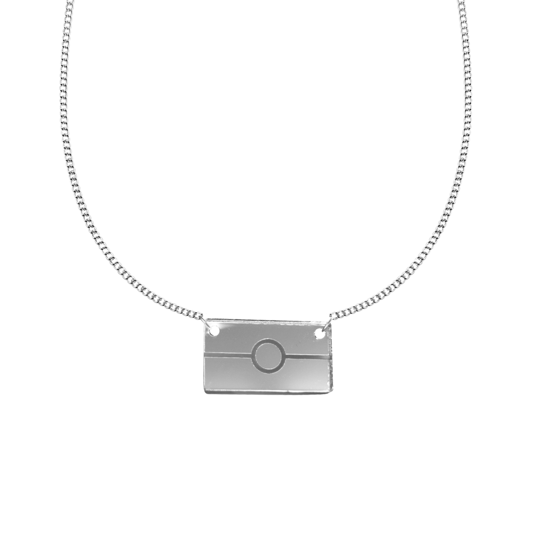 silver mirror acrylic rectangle pendant necklace with engraved Aboriginal flag. It is on a white background. size small