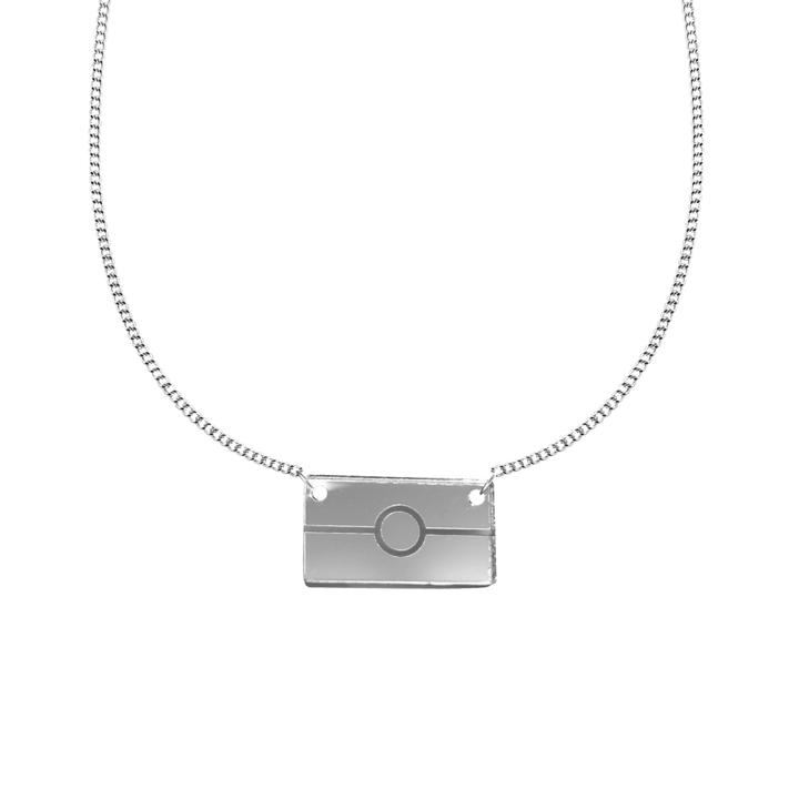 silver mirror acrylic rectangle pendant necklace with engraved Aboriginal flag. It is on a white background. size small