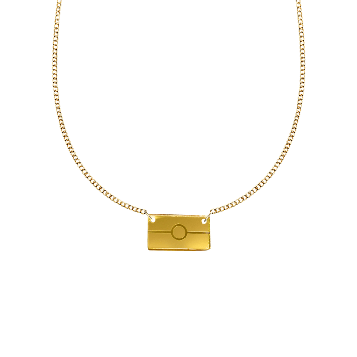 Gold mirror acrylic rectangle pendant necklace with engraved Aboriginal flag. It is on a white background. size extra small