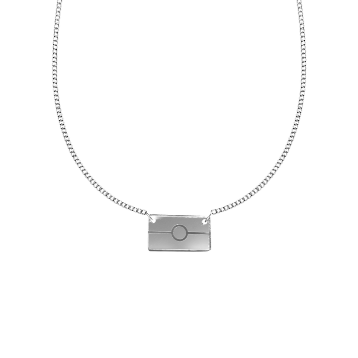 silver mirror acrylic rectangle pendant necklace with engraved Aboriginal flag. It is on a white background. size exta small