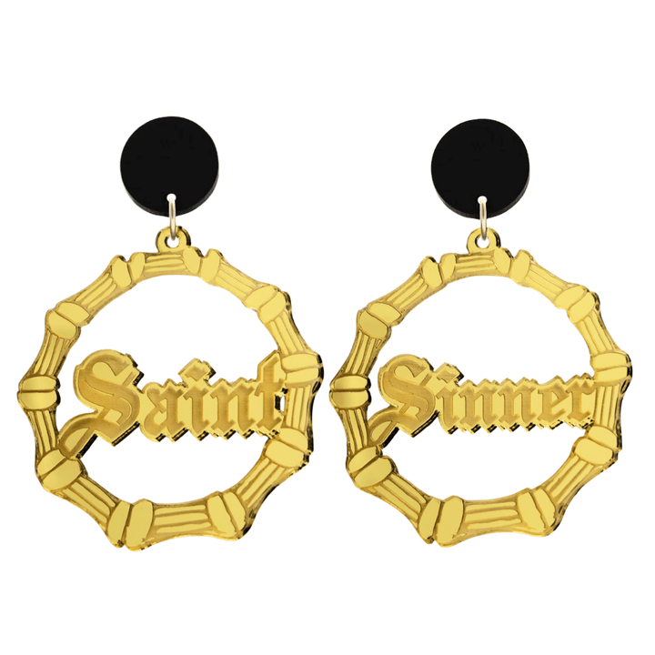 haus of dizzy saint sinner acrylic bamboo hoop earrings in a gothic Old English font, with one hoop reading “Saint” and the other “Sinner,” in a gold mirror acrylic with black circle stud tops size large