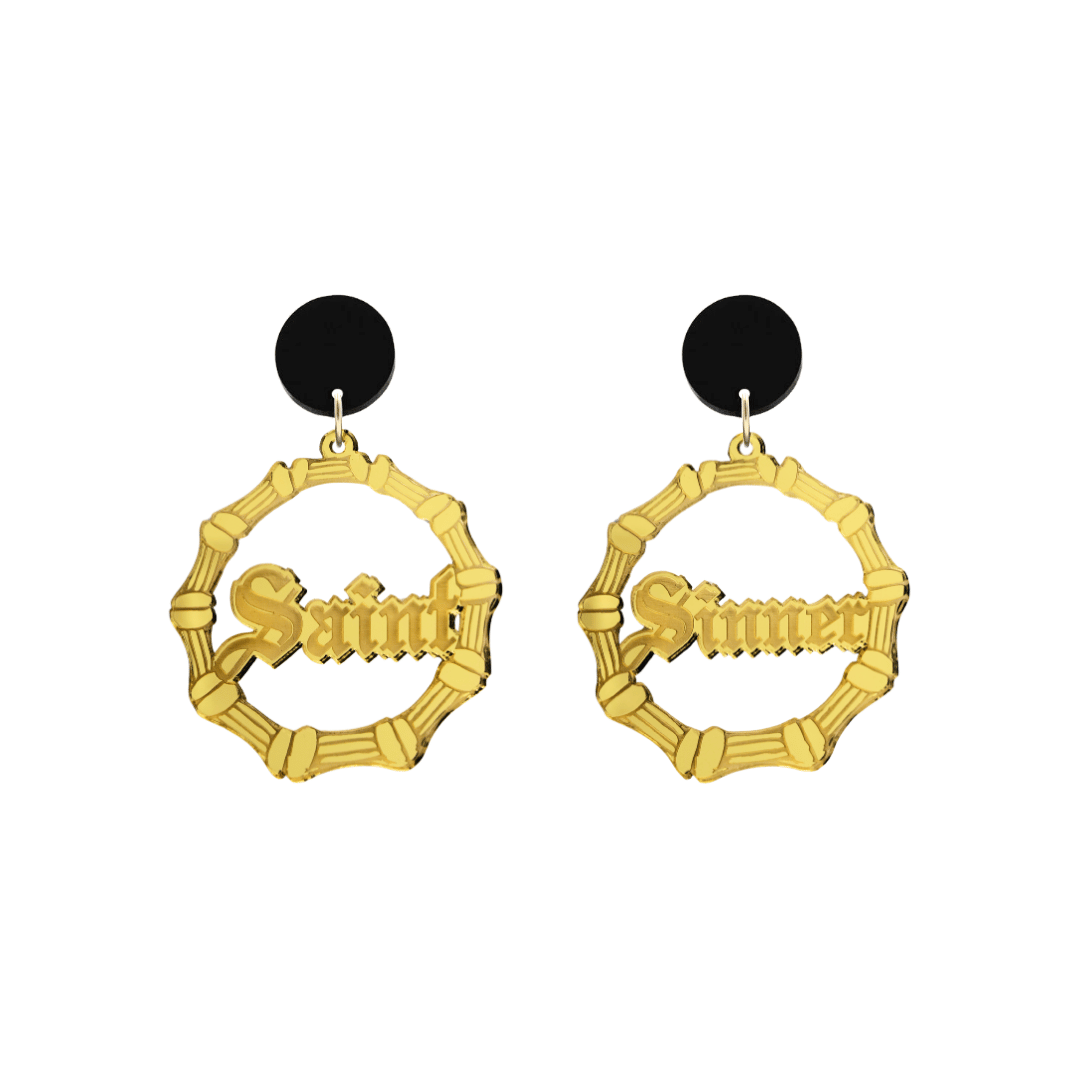 haus of dizzy saint sinner acrylic bamboo hoop earrings in a gothic Old English font, with one hoop reading “Saint” and the other “Sinner,” in a gold mirror acrylic with black circle stud tops size small