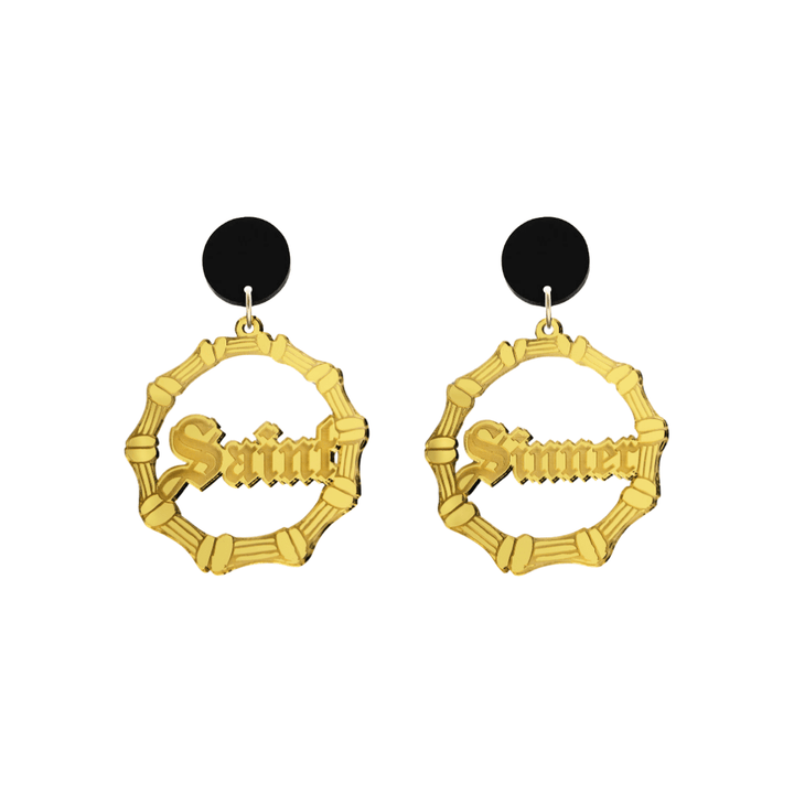haus of dizzy saint sinner acrylic bamboo hoop earrings in a gothic Old English font, with one hoop reading “Saint” and the other “Sinner,” in a gold mirror acrylic with black circle stud tops size small