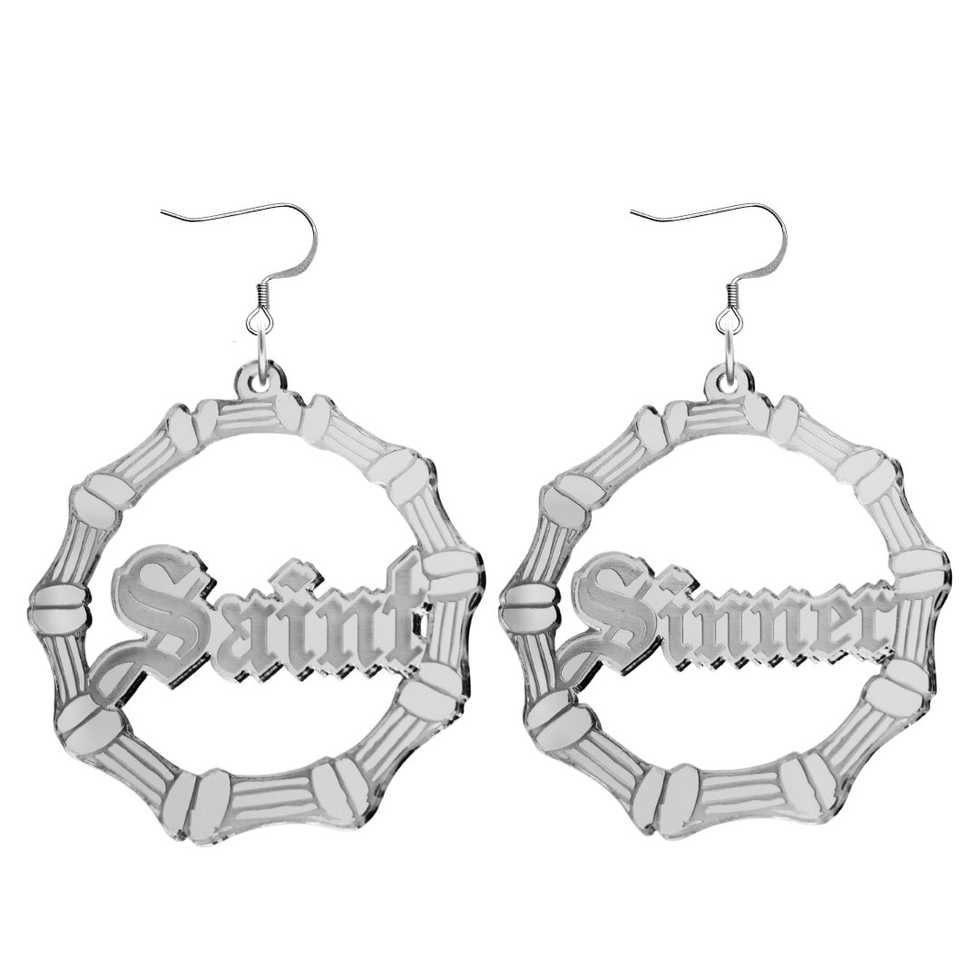 haus of dizzy saint sinner acrylic bamboo hoop earrings in a gothic Old English font, with one hoop reading “Saint” and the other “Sinner,” in a silver mirror acrylic with hooks no circle stud tops size large