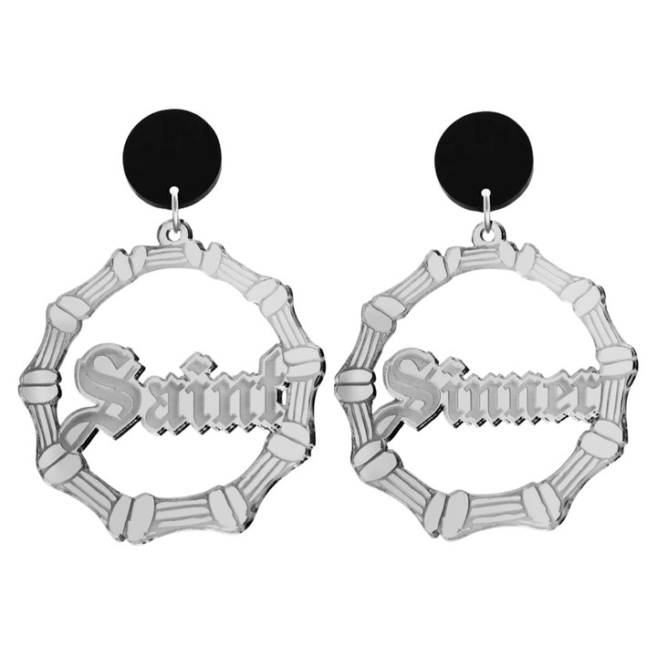 haus of dizzy saint sinner acrylic bamboo hoop earrings in a gothic Old English font, with one hoop reading “Saint” and the other “Sinner,” in a silver mirror acrylic with black circle stud tops size large