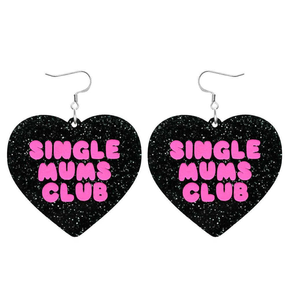 haus of dizzy earrings with a black glittery acrylic heart shape body with the phrase 'single mums club' hand painted in hot pink size large with hooks no heart tops
