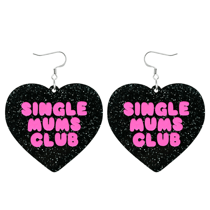 haus of dizzy earrings with a black glittery acrylic heart shape body with the phrase 'single mums club' hand painted in hot pink size large with hooks no heart tops