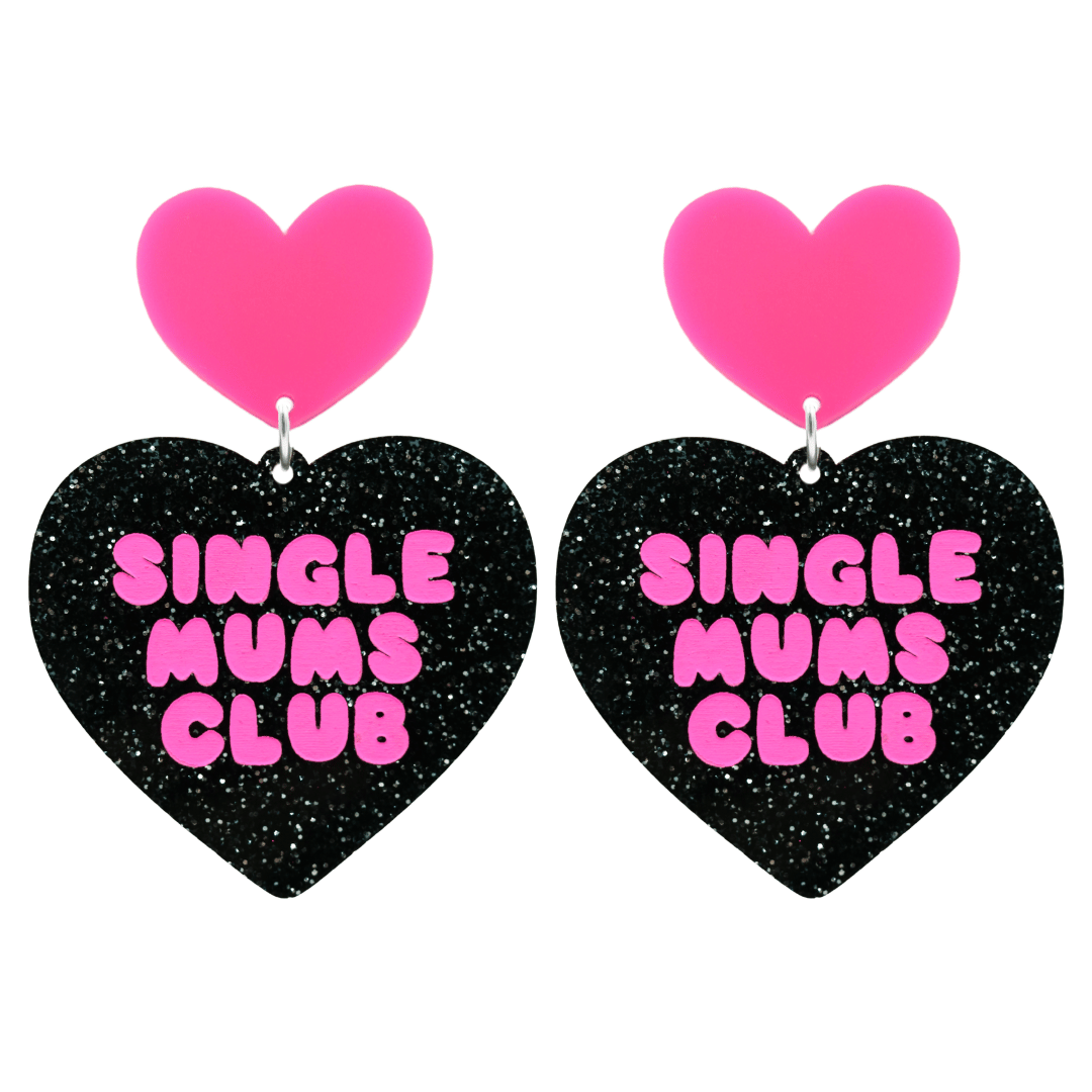 haus of dizzy earrings with a black glittery acrylic heart shape body and a hot pink acrylic top in the shape of a heart, with the phrase 'single mums club' hand painted in hot pink size large
