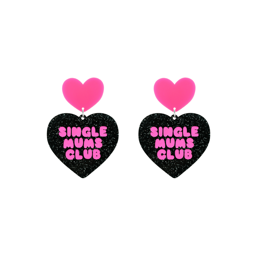 haus of dizzy earrings with a black glittery acrylic heart shape body and a hot pink acrylic top in the shape of a heart, with the phrase 'single mums club' hand painted in hot pink size small