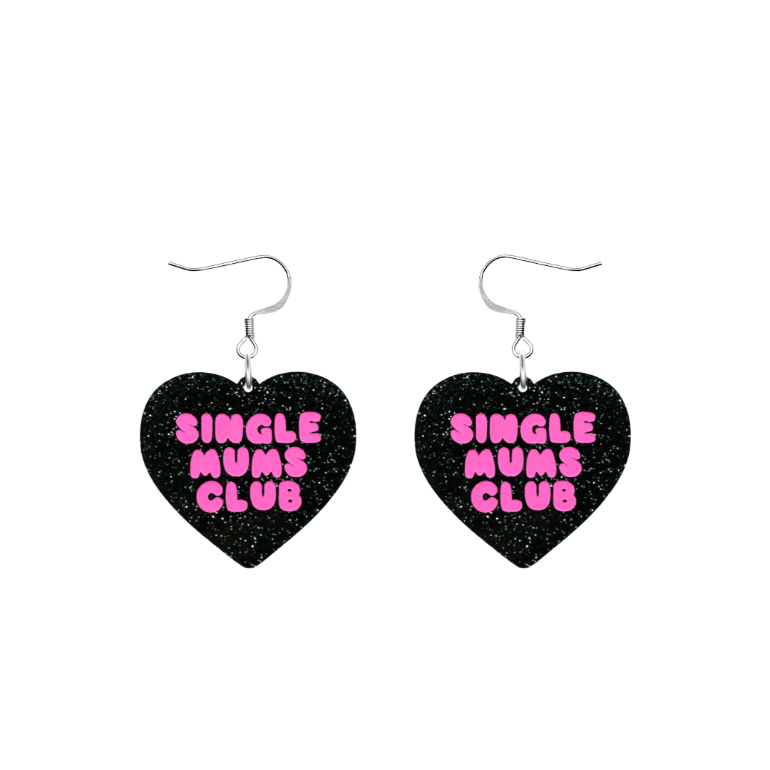 haus of dizzy earrings with a black glittery acrylic heart shape body with the phrase 'single mums club' hand painted in hot pink size small with hooks no heart tops
