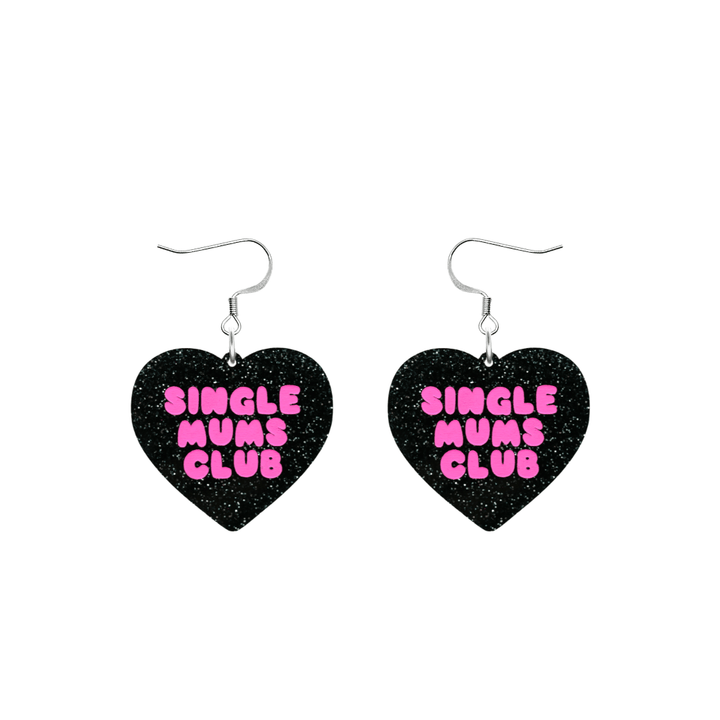 haus of dizzy earrings with a black glittery acrylic heart shape body with the phrase 'single mums club' hand painted in hot pink size small with hooks no heart tops