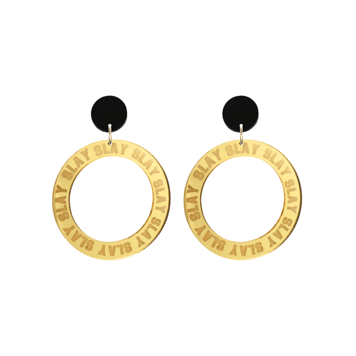 haus of dizzy mirror gold acrylic hoop earrings with repeated 'SLAY' etched text around the hoop size small with black circle tops