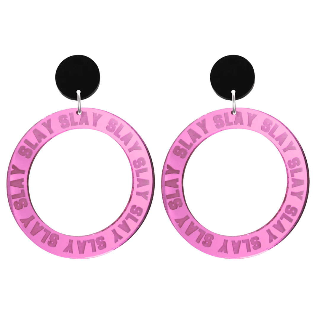 haus of dizzy mirror pink acrylic hoop earrings with repeated 'SLAY' etched text around the hoop size large with black circle tops