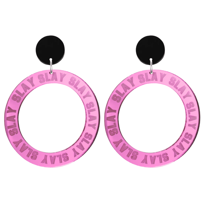 haus of dizzy mirror pink acrylic hoop earrings with repeated 'SLAY' etched text around the hoop size large with black circle tops