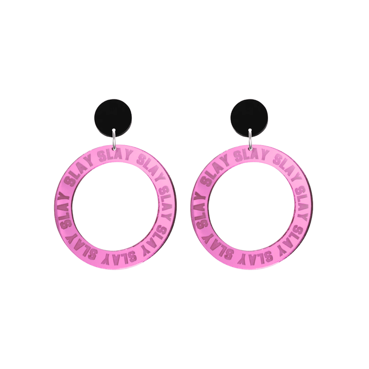 haus of dizzy mirror pink acrylic hoop earrings with repeated 'SLAY' etched text around the hoop size small with black circle tops