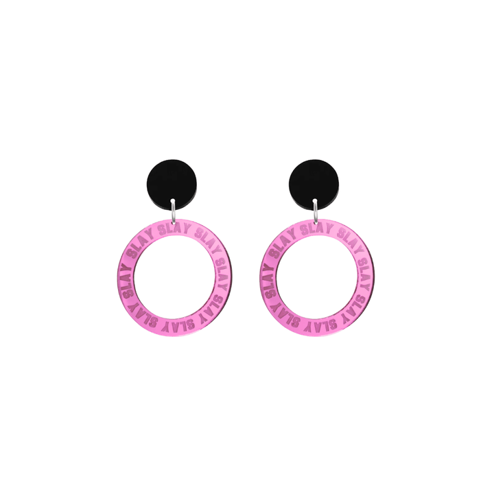 haus of dizzy mirror pink acrylic hoop earrings with repeated 'SLAY' etched text around the hoop size extra small with black circle tops