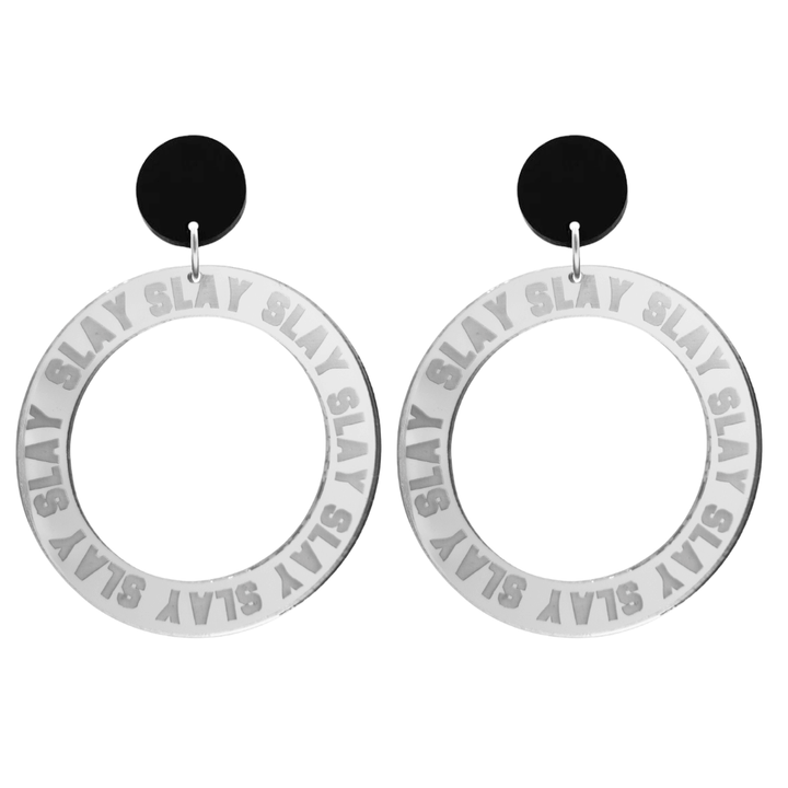 haus of dizzy mirror silver acrylic hoop earrings with repeated 'SLAY' etched text around the hoop size large with black circle tops