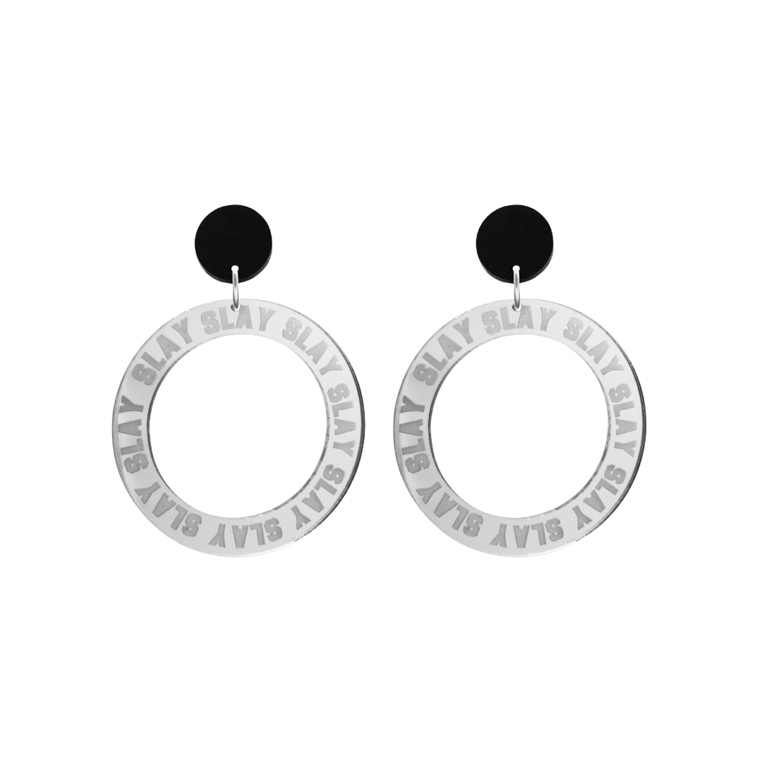 haus of dizzy mirror silver acrylic hoop earrings with repeated 'SLAY' etched text around the hoop size small with black circle tops