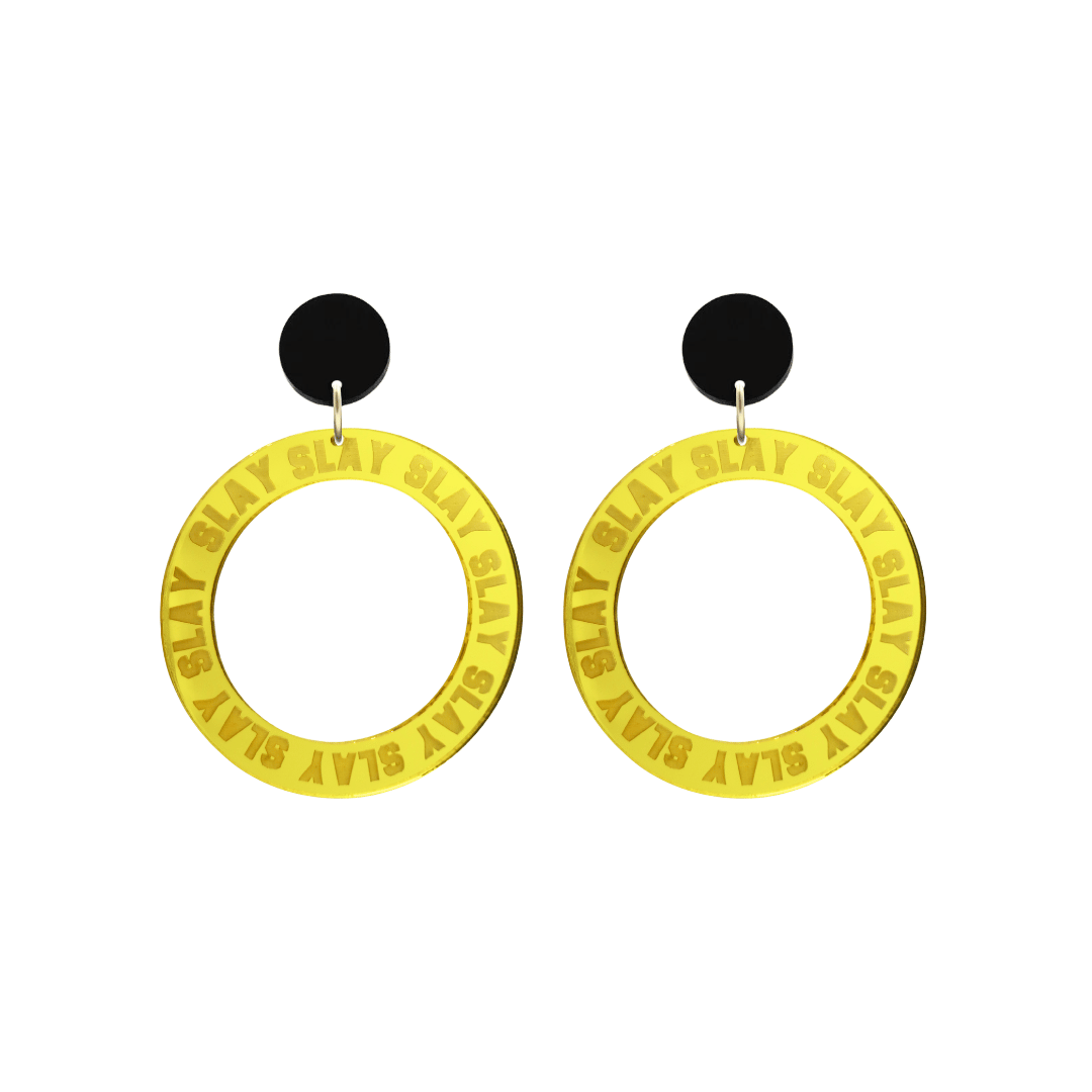 haus of dizzy mirror yellow acrylic hoop earrings with repeated 'SLAY' etched text around the hoop size small with black circle tops