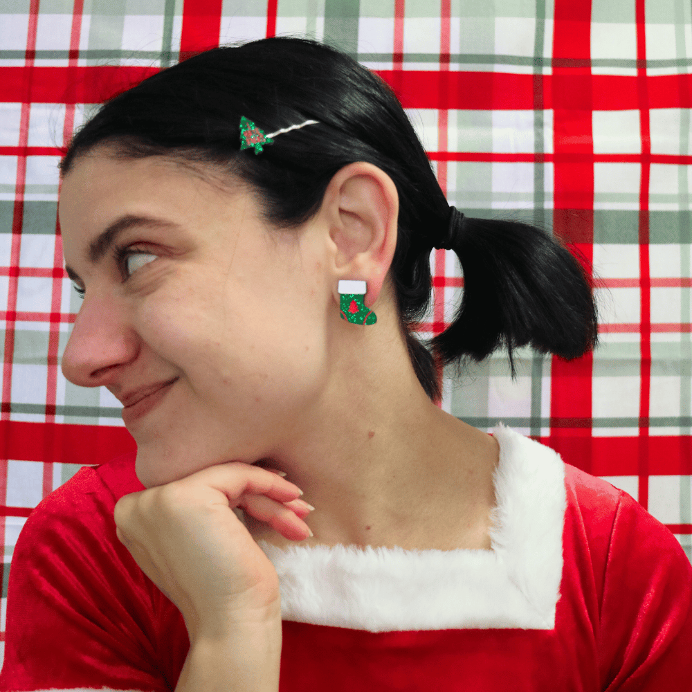 model wearing santa outfit and haus of dizzy twinkle toe glitter stocking studs in green glitter looking away from camera