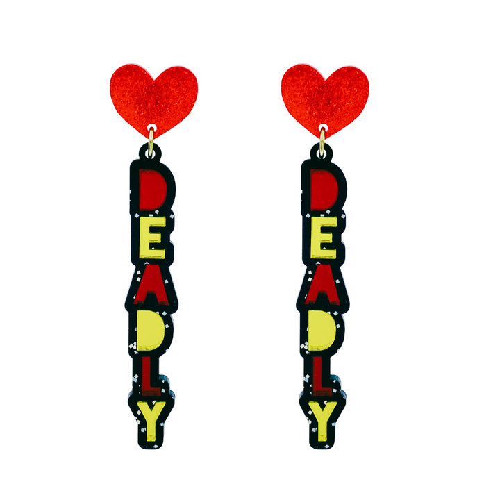 An image of Haus of Dizzy's dangle ‘Deadly’ stacked earrings, with red and yellow mirror deadly text on black glitter acrylic and a red glitter heart top.