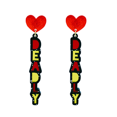 An image of Haus of Dizzy's dangle ‘Deadly’ stacked earrings, with red and yellow mirror deadly text on black glitter acrylic and a red glitter heart top.