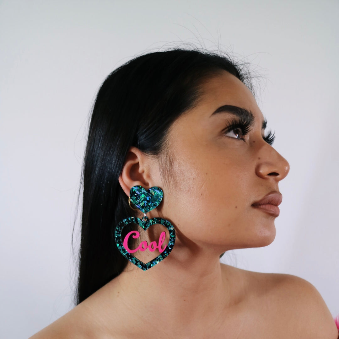 model wearing haus of dizzy cool mum earrings in size large in emerald ice and hot pink