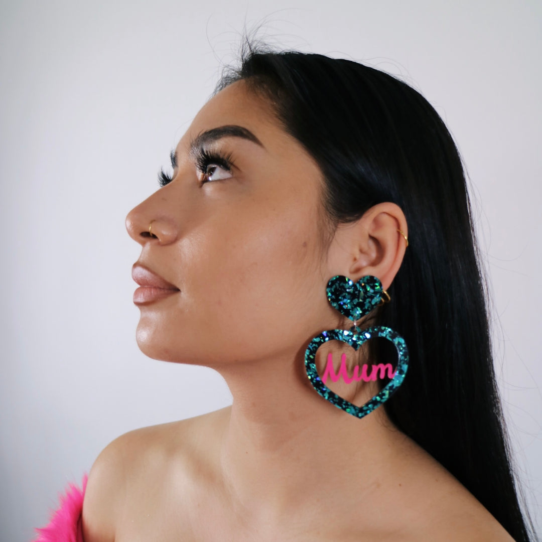 model wearing haus of dizzy cool mum earrings in size large in emerald ice and hot pink